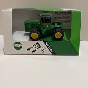 Ertl John Deere 4wd tractor, motorized action. 1/64 scale. Item 551. Unopened.
